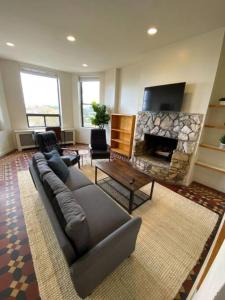 a living room with a couch and a fireplace at Wonderful Fenway 3 Bed 2bath Steps from Fenway Park in Boston