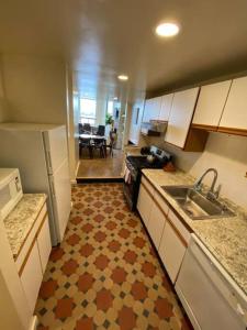 a kitchen with a sink and a counter top at Wonderful Fenway 3 Bed 2bath Steps from Fenway Park in Boston