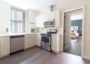 a kitchen with white cabinets and a stove top oven at Downtown Boston 1BR Keyless Entry Fast Wifi in Boston