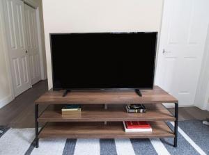 a flat screen tv sitting on top of a wooden entertainment center at Downtown Boston 1BR Keyless Entry Fast Wifi in Boston