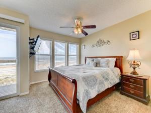 a bedroom with a bed and a ceiling fan at Surfside Six E Unit 5 in Saint Augustine