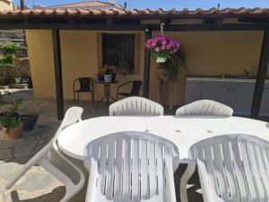 a white table and four white chairs on a patio at Hermes in Amigdhaleón