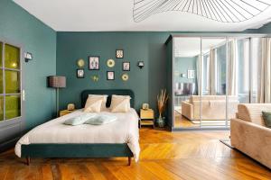 a bedroom with a bed with a green wall at Nancy Vieille Ville Stanislas in Nancy +63 photos