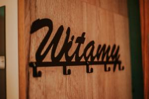 a wooden door with the word kitchen written on it at Ostrowo LATEM in Ostrowo