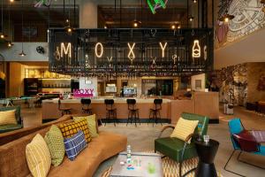 上海上海普陀Moxy酒店的大堂配有沙发、椅子和酒吧