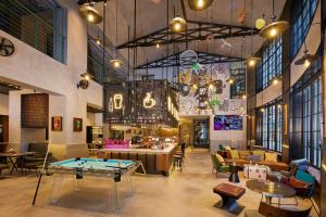 a restaurant with a ping pong table in a room at Moxy Shanghai Putuo in Shanghai