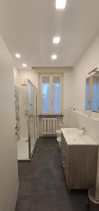 a bathroom with a shower and a sink and a tub at Nina B&B in Rho