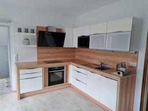 a kitchen with white cabinets and a sink at Landhaus Kölbl in Turnau