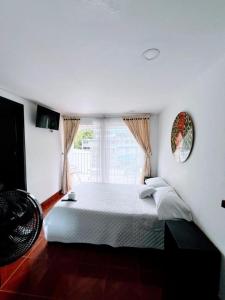 Postel nebo postele na pokoji v ubytování Hotel Zipa Villeta - Sede Tradicional