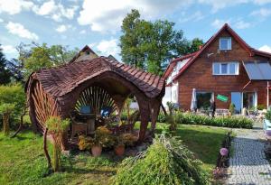 a gingerbread house in the yard of a house at Bonaluti Adults - Azyl Dla Dorosłych in Mirsk
