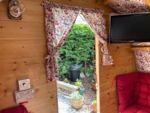 a view of a room with a window and a tv at Alnmouth Glamping in Alnmouth