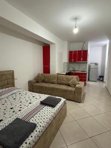 a living room with a bed and a couch at Lejdon Daily Apartments Shengjin in Shëngjin