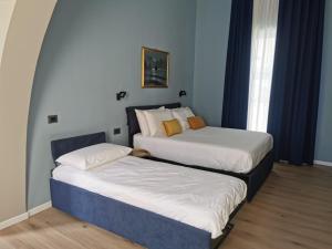 Ένα ή περισσότερα κρεβάτια σε δωμάτιο στο Home 109 Luxury Rooms