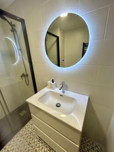 a bathroom with a sink and a mirror at El sueño de Verónica in Cudillero +20 photos