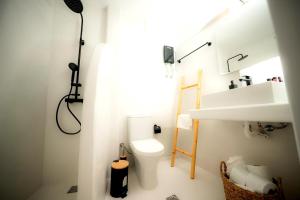 a bathroom with a toilet and a sink at Kythrooms 2 in Kithnos