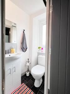 a bathroom with a white toilet and a sink at Little Dockray Two-Bedroom Apartment Centre of Penrith in Penrith