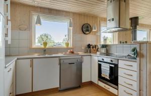 a kitchen with a sink and a stove at Holiday Home Sommerstedvej Denm in Vinderup