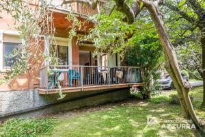 a house with a porch with chairs on it at Darina - Immobiliare Azzurra in Lazise