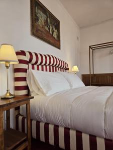 a bedroom with a large bed with red and white stripes at Villa Habana in Fonte Nuova