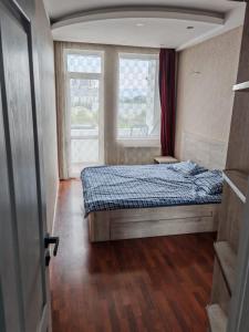 a small bedroom with a bed and a window at Tbilisi LUXURY APARTMENT in Tbilisi City