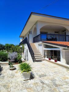 a house with a staircase and a patio at CASA DORI in Cisternino