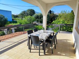 a table and chairs sitting on a patio with a table and chairs at CASA DORI in Cisternino