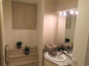a bathroom with a sink and a mirror at Maison Centre Historique in Sarlat-la-Canéda +8 photos