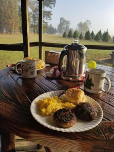 a plate of eggs and donuts on a wooden table at Rural life on a real Christmas tree farm! Hallmark experience! in Ozark