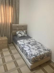 a bed sitting in a room with at Apartamentos nuevos in Chefchaouen