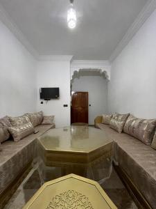 a living room with a couch and a coffee table at Apartamentos nuevos in Chefchaouene +13 photos