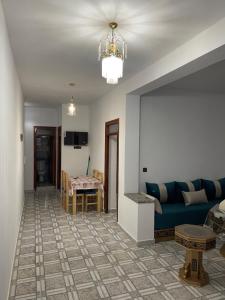 a living room with a blue couch and a table at Apartamentos nuevos in Chefchaouen