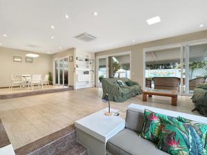 a living room with a couch and a table at 200m from the Beach 9 Qts AC Pool Grill in Guarujá +51 photos