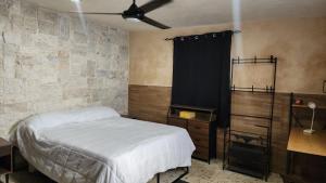 a bedroom with a bed and a black curtain at La Casa del Arbol in Chelem +13 photos
