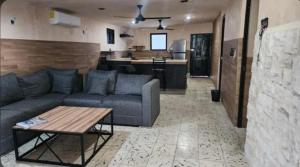 a living room with a couch and a table at La Casa del Arbol in Chelem