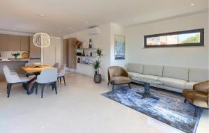 a living room with a couch and a table at Awesome Home In Basanija With Kitchen in Bašanija