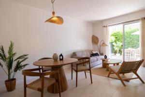 a living room with a table and chairs and a couch at Place to beach - Bord de mer Croisette in Cannes