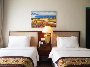 Postel nebo postele na pokoji v ubytování Kapitan Kongsi Boutique Hotel