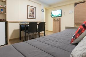 a bedroom with a bed and a table with chairs at Patagonia suites Bariloche in San Carlos de Bariloche
