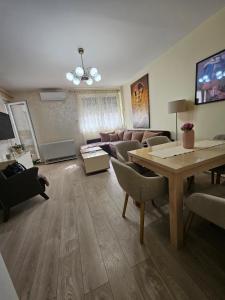 a living room with a couch and a table at Anastasija Lux 2 in Paraćin +15 photos