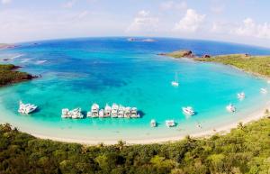 an aerial view of a beach with boats in the water at Black & White Comfort Studio in San Juan