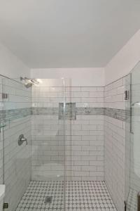 a bathroom with a shower with a tiled floor at Downtown Condo Walk to GWCC and Coca-Cola in Atlanta