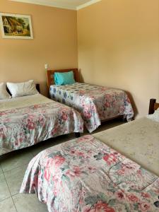 Cama o camas de una habitación en Pousada Cascata de Pedra