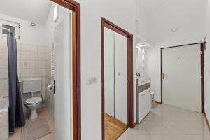 a bathroom with a toilet and a mirror at Apartman Lorena in Fažana +11 photos