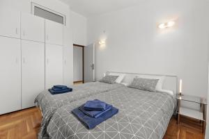 a bedroom with a bed with blue towels on it at Apartman Lorena in Fažana