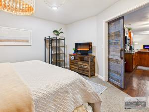 a bedroom with a bed and a tv and a door at 2 spaces More Space with 2 units at same location PNW Retreat in Philomath +37 photos