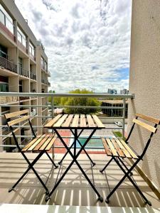 a picnic table and two chairs on a balcony at The Urban Studio Madrid in Madrid