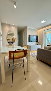a living room with a table and a couch at Apartamento Villa Park Natal in Natal