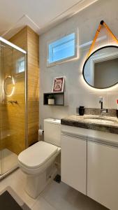 a bathroom with a toilet and a sink and a shower at Apartamento Villa Park Natal in Natal +33 photos
