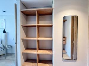 a closet with wooden shelves and a mirror at Edificio QO 97 By Jalo in Bogotá