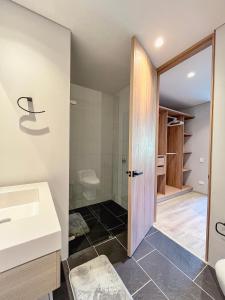 a bathroom with a white sink and a shower at Edificio QO 97 By Jalo in Bogotá